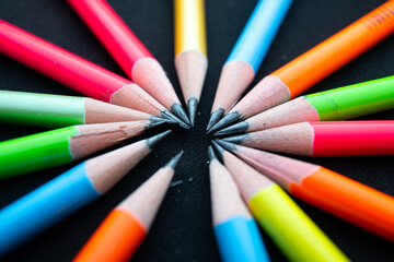 colored pencils on black background