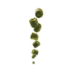 Hop granules showcased vividly. Closeup of hop particles gleaming. Bright studio shot highlighting hopping ingredients for brewing excellence