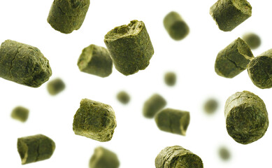 Dynamic image of hop pellets. Suspended hop pellets with aromatic essence. Floating green hops emphasizing freshness and fragrant aroma qualities