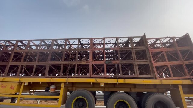 Heavy-Duty Trailer Transporting Large Steel Structure on Highway