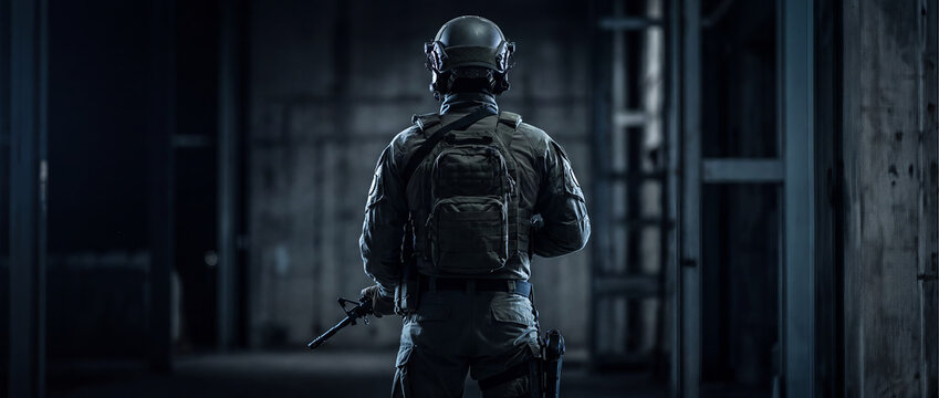 SWAT Team Member Seen from Behind in Dark Tactical Environment