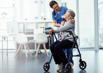 Fototapeta premium Wheelchair, help and caregiver with senior woman in clinic for support, medical service and talking. Healthcare, hospital and nurse with elderly person with disability for wellness, care and bonding