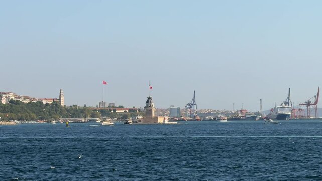 View of Maiden Tower and port cranes across the Bosphorus on a clear sunny day