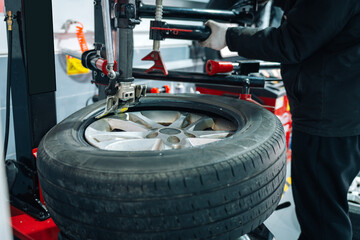 Car Wheel Tire Being Mounted at Auto Repair Shop
