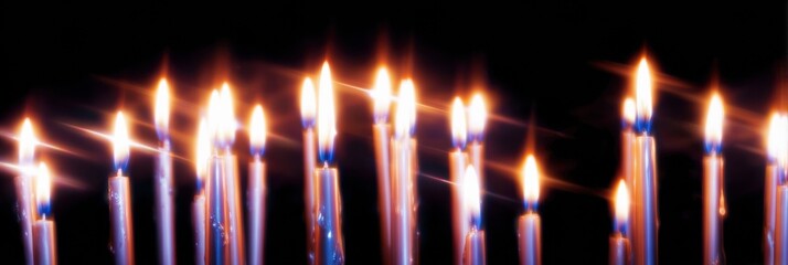 Prayer candles burning in church with flickering flames on dark background as symbol of faith and religious devotion for christianity concept and prayer meditation