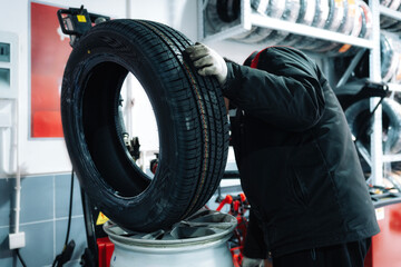 Mechanic Working on Tire and Rim in Workshop