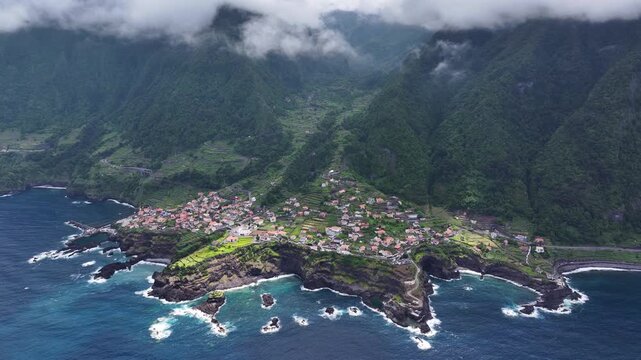 Natural beauty of Seixal village on rugged coastline of Madeira. Aerial push-in