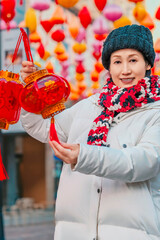 Elderly Chinese Woman with Red Lanterns Outdoors