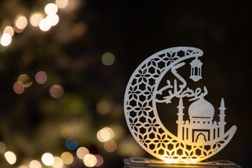 Elegant crescent moon and mosque Ramadan decoration with Arabic calligraphy and glowing bokeh lights, perfect for festive holy month greetings and decor    © Ricky