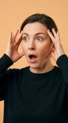 Surprised Mature Woman With Shocked Facial Expression Over Orange