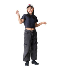 Cheerful young girl wearing casual streetwear clothes and a cap joyfully dancing and expressing...