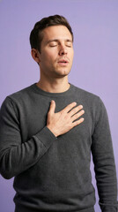 Young Man With Hand On Chest Feeling Relieved And Grateful
