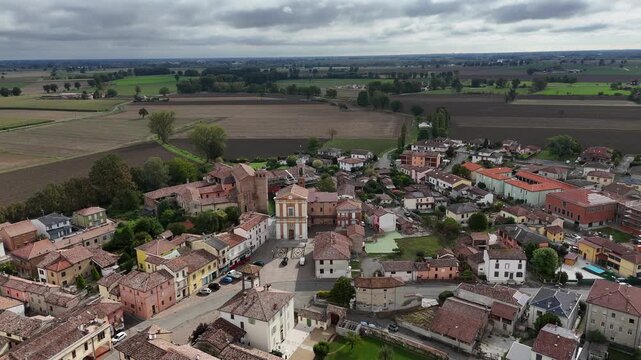 Aerial view of Calendasco village with fortified castle and Santa Maria Assunta church in Italy