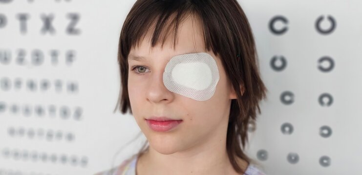 Child undergoing eye patch treatment in an optometry clinic for vision improvement concept