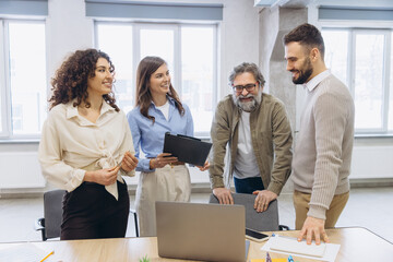 Fototapeta premium Business professionals collaborating at a meeting, discussing ideas and sharing information in a modern office environment