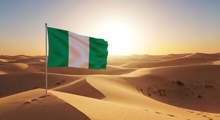 Nigerian flag waving in the desert sand dunes at sunset.