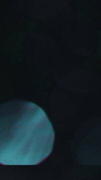 Dark Vertical Optical Bokeh Light Transition, Blue Abstract Bokeh Light Motion Across Darkness. great for overlay effect