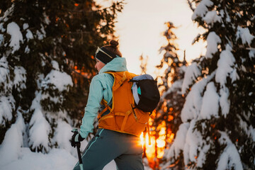 Mountaineer backcountry ski walking ski alpinist in the mountains. Ski touring in alpine landscape with snowy trees. Adventure winter sport. Low Tatras, slovakia