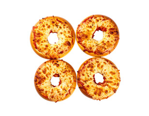 Four baked pizza-bagels arranged in a square, top-down view