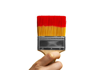 Close-up of a hand holding a paintbrush with red paint on a yellow background, actively painting. A vibrant image capturing the essence of painting and color application.