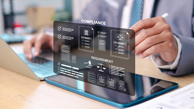 Businessman reviewing digital compliance dashboard with legal documents, requirements, and governance system on tablet and laptop. Concept of regulatory control and corporate compliance management.