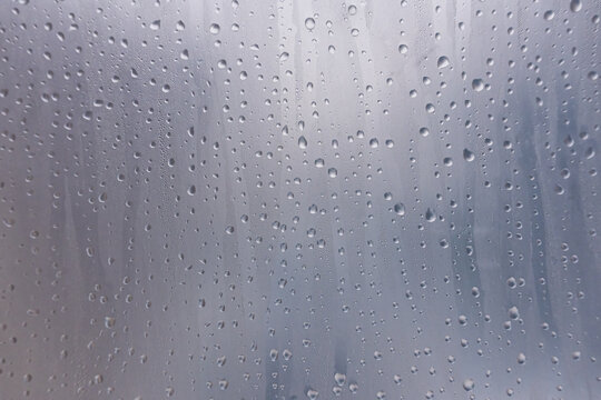 Close-up of condensation droplets on a fogged plastic film. The fresh, misty texture is perfect for creating realistic backgrounds, humidification, cold, advertising, or design overlay effects.