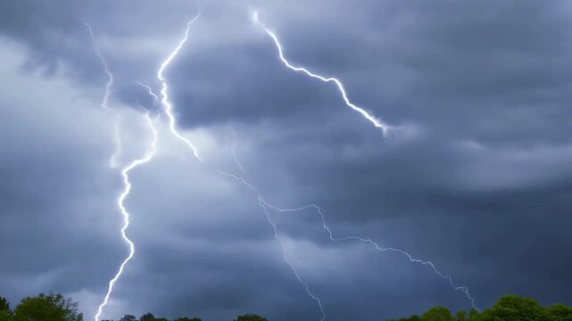 Intense footage of forked lightning bolts striking through thick, dark storm clouds during a heavy tempest.