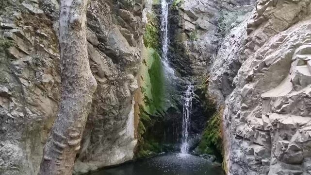 Dramatic waterfall in narrow Cyprus rocky gorge