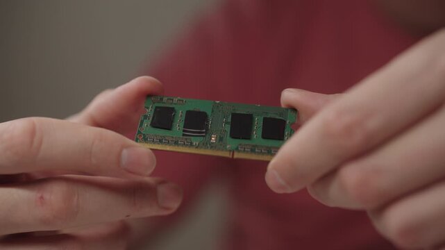 Technician hands holding ram module, performing component inspection, diagnosing computer hardware, upgrading memory, maintaining electronic device performance. Concept of PC maintenance and service.