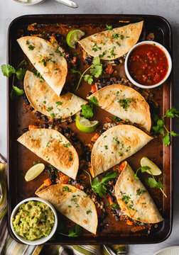 Close up of sheet pan baked beef and bean tacos with guacamole.