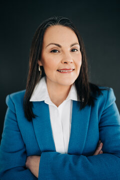 Professional woman smiling with arms crossed representing confidence