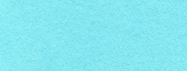 Fototapeta premium Light blue textured paper background with subtle grain surface and structure. Pastel turquoise paper backdrop, macro
