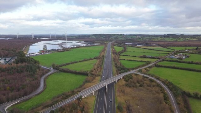 Aerial View Of M7 Motorway, Solar Farm And Wind Turbines In Tipperary, Ireland.