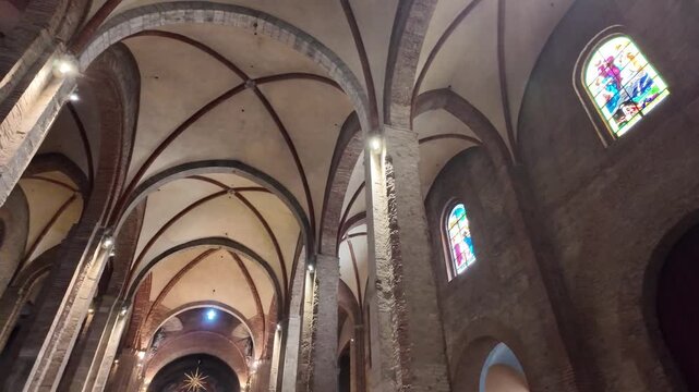 Inside historic church, vaulted arches and stained glass in Corso Garibaldi, Milan, Italy. Atmospheric sacred architecture for travel, culture, heritage, and tourism use