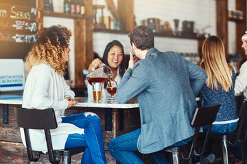 Fototapeta premium Beer, back and date with couple at bar for bonding, restaurant diner and valentines day event. Conversation, alcohol drink and pint with man and woman at pub for relationship, glass and love