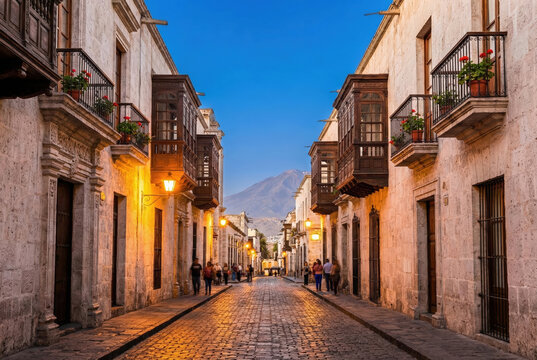 Cobblestone street in Arequipa with traditional colonial balconies and Misti volcano at sunset