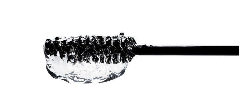 Close-up photo of Essence serum gel for eyebrows and eyelashes on a brush on transparent background