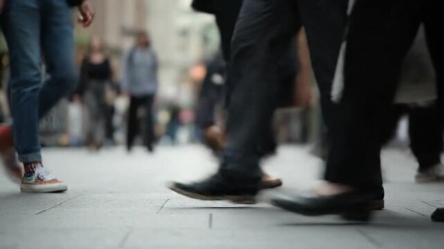 Busy Pedestrians Walking on City Sidewalk Close Up of Shoes and Feet in Urban Crowded Street Scene with Motion Blur and Low Angle View