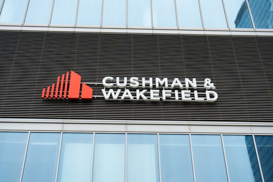 Cushman and Wakefield logo sign on office building. American global firm, commercial real estate services, property management, investment. Signage with brand logo on March 2, 2025 in Krakow, Poland.