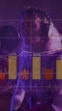 Vertical video: Female singer starting playing guitar and singing into mic, charts mapping music