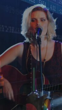 Vertical video: Female singer performing song while camera settling numeric panels over artist