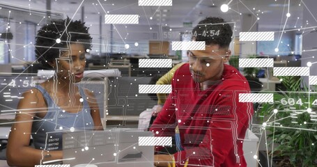 Collaborating duo in red hoodie and blue top leaning over laptop at office, with data overlay