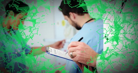 Writing doctor in white coat with blue clipboard noting gowned patient in clinic, green overlay