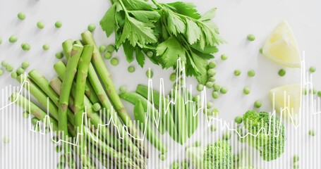 Displaying bundled asparagus spears on white marble tabletop, with peas, lemon, waveform overlay © vectorfusionart