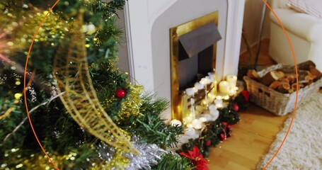 Obraz premium Glowing decorated Christmas tree on left casting warm light near fireplace, lit candles, copy space