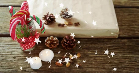 Fotobehang Vlees Showing festive tabletop jar with red ribbon holding candy canes on rustic plank, lit tealight  © vectorfusionart