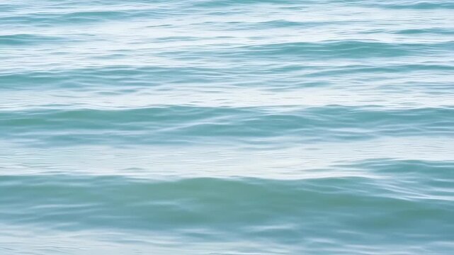 Calm, turquoise ocean surface with subtle, rippled wave patterns