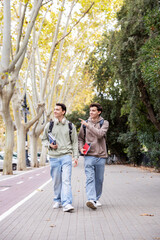 University students enjoying autumn stroll and lively conversation