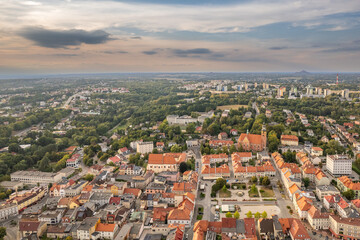 Obraz premium Aerial Drone Panorama of Historic European Town at Dusk with Red Roofs
