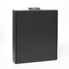 Black cardboard box isolated on white background. Minimalist packaging with smooth surface, studio lighting, no logos or text.